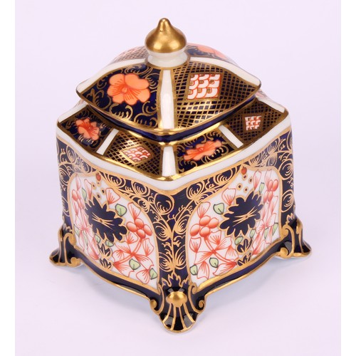 213 - A Royal Crown Derby 1128 Imari pattern shaped square inkwell, of casket form, the domed cover enclos... 