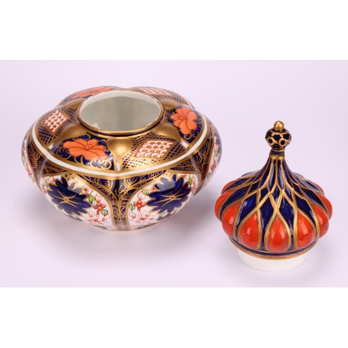 241 - An associated pair of Royal Crown Derby 1128 Imari pattern lobed ovoid vases and covers, of compress... 