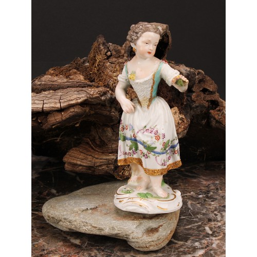 276 - A Meissen porcelain figure, of a girl wearing a floral dress, with posies in hand, scroll base, pick... 