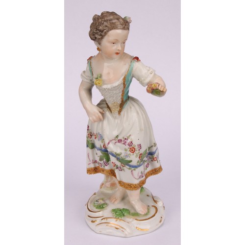 276 - A Meissen porcelain figure, of a girl wearing a floral dress, with posies in hand, scroll base, pick... 