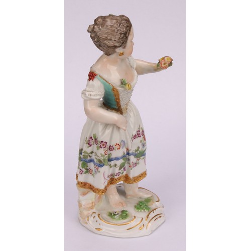 276 - A Meissen porcelain figure, of a girl wearing a floral dress, with posies in hand, scroll base, pick... 