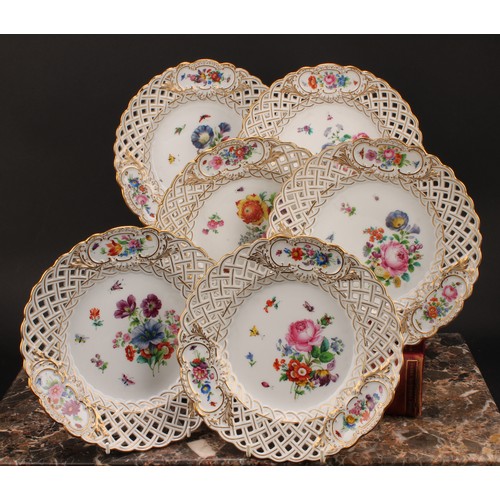 292 - A set of six German porcelain shaped circular plates, decorated with flowers, pierced borders picked... 