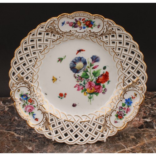 292 - A set of six German porcelain shaped circular plates, decorated with flowers, pierced borders picked... 