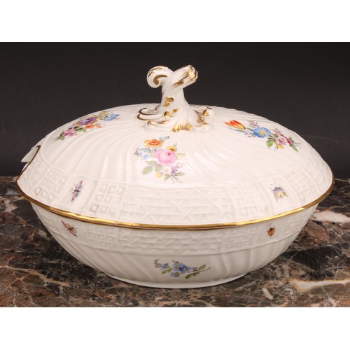 273 - A German porcelain oval tureen and cover, moulded with flutes and diapers and decorated in polychrom... 