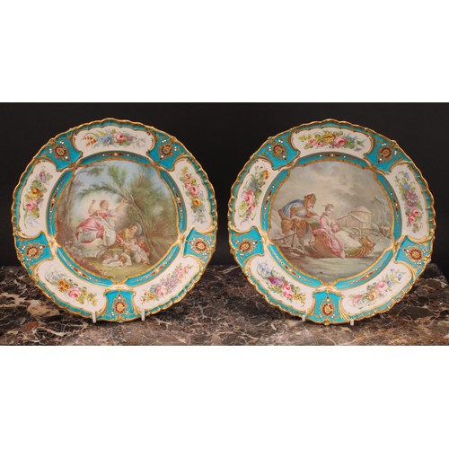 288 - A pair of Sevres shaped circular plates, painted by L Vergniaud, signed, with a courting couple in a... 