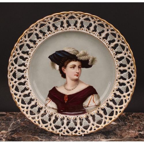 270 - A Continental porcelain shaped circular charger, painted and printed with a portrait of a young lady... 