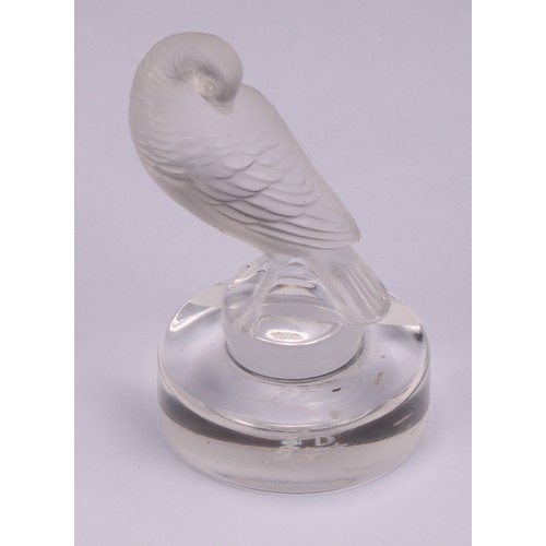 300 - A Lalique frosted glass place card holder, modelled as a turtle dove preening, circular base, engrav... 