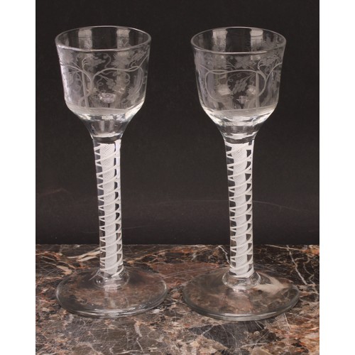 309 - A pair of George III opaque twist drinking glasses, the bowl etched with leafy fruiting vine and Jac... 