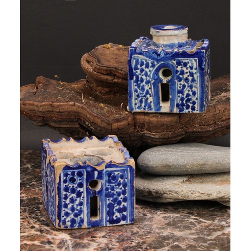 319 - A 19th century Moroccan pottery inkwell and cover, in the form of a quba, painted in blue with panel... 