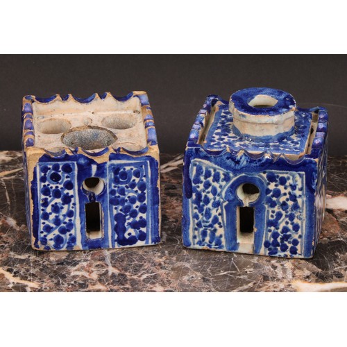 319 - A 19th century Moroccan pottery inkwell and cover, in the form of a quba, painted in blue with panel... 