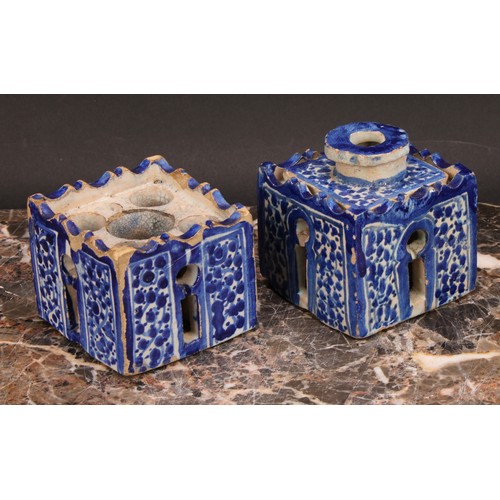 319 - A 19th century Moroccan pottery inkwell and cover, in the form of a quba, painted in blue with panel... 