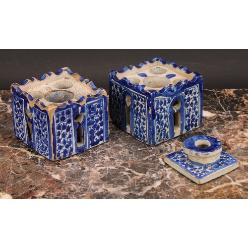 319 - A 19th century Moroccan pottery inkwell and cover, in the form of a quba, painted in blue with panel... 