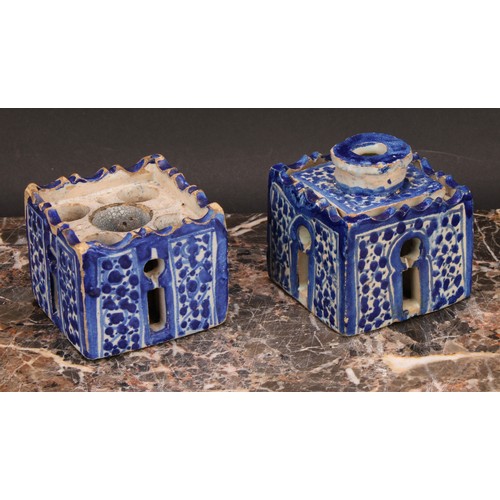 319 - A 19th century Moroccan pottery inkwell and cover, in the form of a quba, painted in blue with panel... 