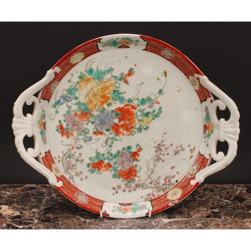 363 - A Japanese two-handled circular tray, painted in polychrome with flowers, 41cm wide, Meiji period