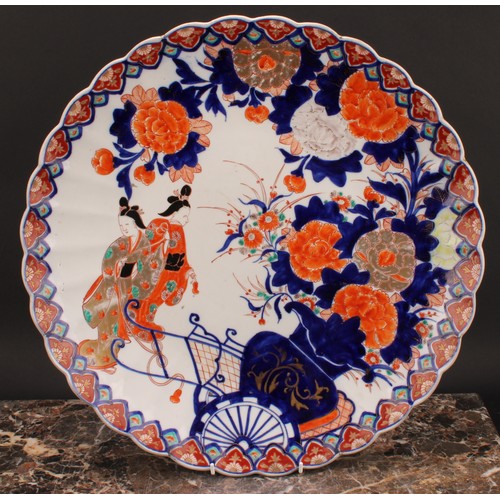 361 - A Japanese scalloped circular charger, painted in the Imari palette with floral vase, rickshaw and G... 