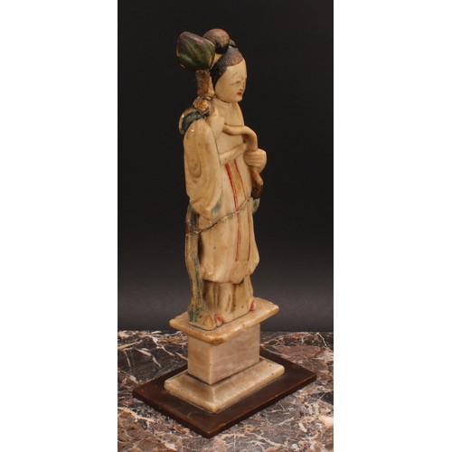 369 - A pair of Chinese soapstone figures, carved as Shou Lao and Guanyin, each picked out in polychrome, ... 