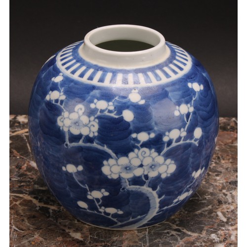 326 - A Chinese ovoid ginger jar, painted in tones of underglaze blue with blossoming prunus on a ground o... 