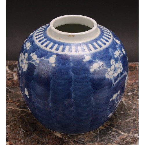 326 - A Chinese ovoid ginger jar, painted in tones of underglaze blue with blossoming prunus on a ground o... 