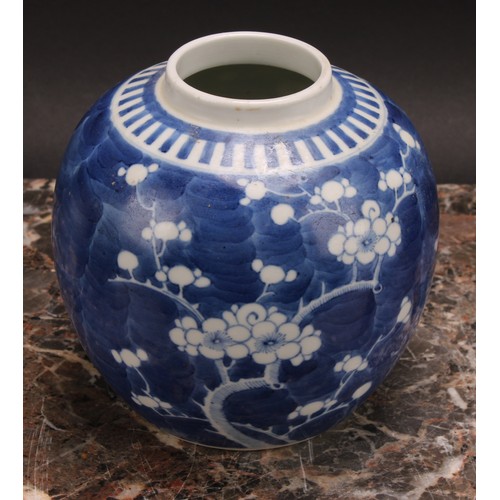 326 - A Chinese ovoid ginger jar, painted in tones of underglaze blue with blossoming prunus on a ground o... 