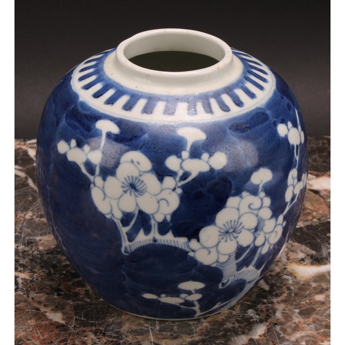 326 - A Chinese ovoid ginger jar, painted in tones of underglaze blue with blossoming prunus on a ground o... 