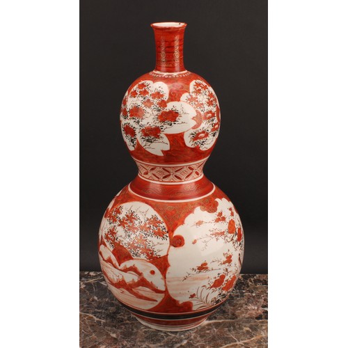 352 - A Japanese Kutani double gourd vase, painted in the typical palette with a deity seated on a phoenix... 