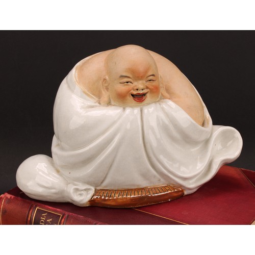 328 - A Chinese pottery figure, of Budai, seated, 19cm high