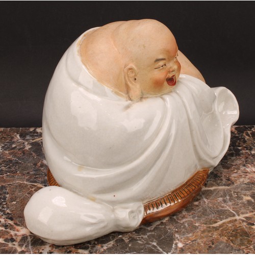 328 - A Chinese pottery figure, of Budai, seated, 19cm high