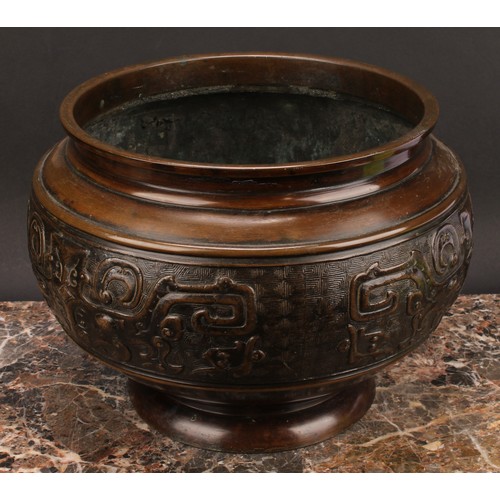 338 - A Chinese patinated bronze ovoid pedestal jardiniere, relief decorated in the Archaic taste, 21cm hi... 