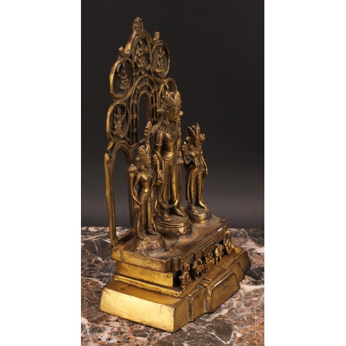 340 - A Chinese/Tibetan gilt bronze shrine figure, cast with three figures, calligraphy script to verso, 2... 