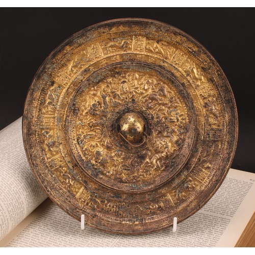 333 - A Chinese gilt bronze mirror, cast in the Archaic taste, 21.5cm diam