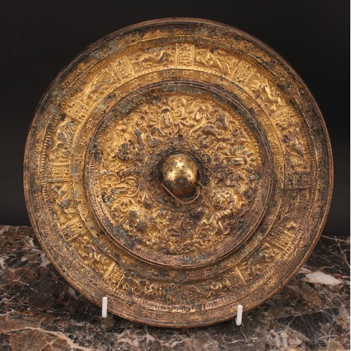 333 - A Chinese gilt bronze mirror, cast in the Archaic taste, 21.5cm diam