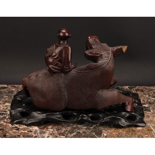 387 - A pair of Chinese hardwood carvings, of boys riding buffalo, pierced hardwood stands, 32cm wide, c.1... 