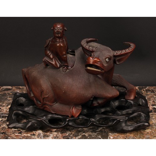 387 - A pair of Chinese hardwood carvings, of boys riding buffalo, pierced hardwood stands, 32cm wide, c.1... 