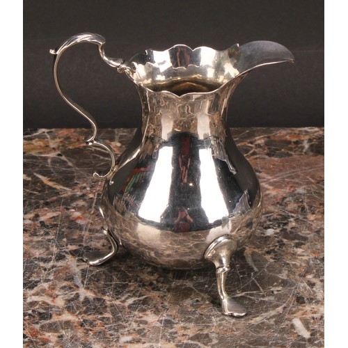 797 - A George III silver baluster cream jug, wavy rim, acanthus-capped scroll handle, shaped pad feet, 10... 