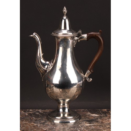 793 - A George III provincial silver baluster coffee pot, hinged lofty domed cover with acorn finial, scro... 