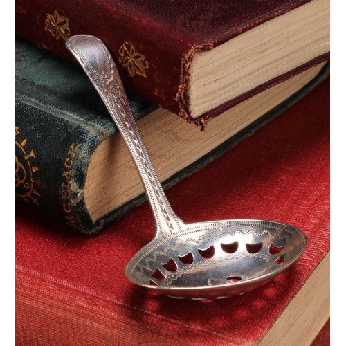 803 - A George III silver caddy spoon, pierced oval bowl, bright-cut and wrigglework engraved, 7.5cm long,... 