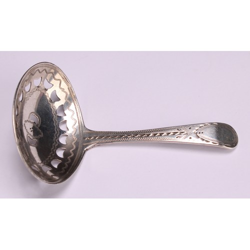 803 - A George III silver caddy spoon, pierced oval bowl, bright-cut and wrigglework engraved, 7.5cm long,... 