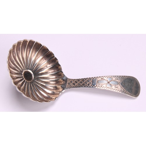 800 - A George III silver caddy spoon, fluted circular bowl, bright-cut and wrigglework engraved stem, 7cm... 