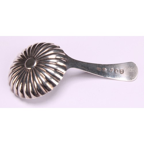 800 - A George III silver caddy spoon, fluted circular bowl, bright-cut and wrigglework engraved stem, 7cm... 