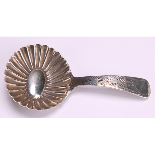 800 - A George III silver caddy spoon, fluted circular bowl, bright-cut and wrigglework engraved stem, 7cm... 