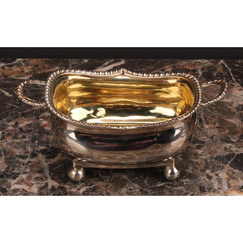 799 - A George III silver boat shaped two-handled salt, gadrooned border, ball feet, gilt interior, 11.5cm... 