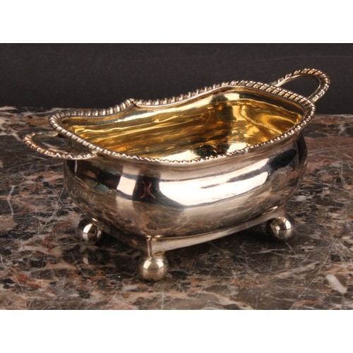 799 - A George III silver boat shaped two-handled salt, gadrooned border, ball feet, gilt interior, 11.5cm... 