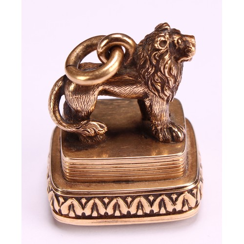 1253 - A 19th century gold coloured metal fob seal, surmounted with a lion, lotus border, the citrine matri... 