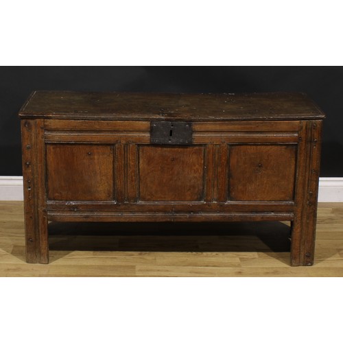 A late 17th century oak blanket chest, hinged top, three panel front ...