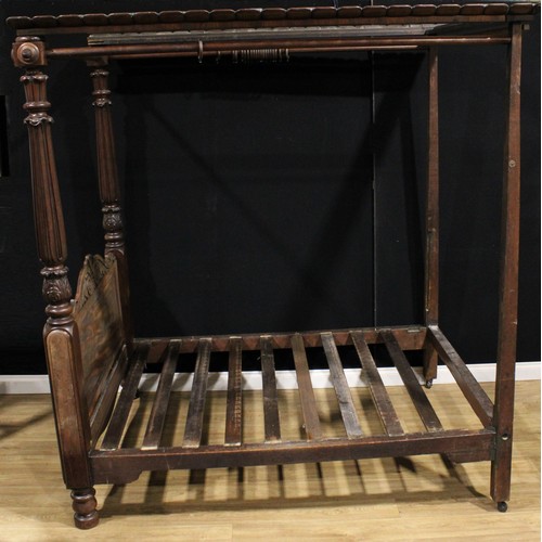 2170 - A William IV mahogany four-poster bed, outswept cornice, the headboard columns carved with stylised ... 