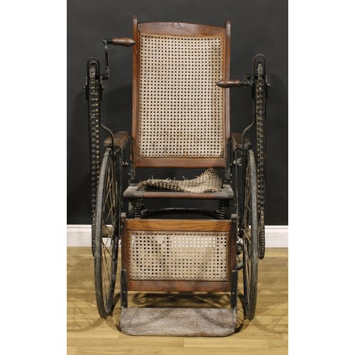 An early to mid20th century American oak handcrank wheelchair, by