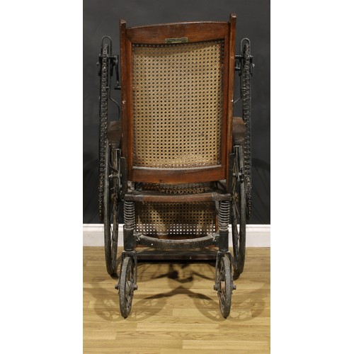 An early to mid20th century American oak handcrank wheelchair, by