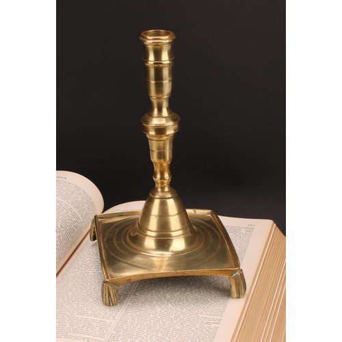 1938 - A Spanish brass tray base socket candlestick, knopped pillar, domed socle, fluted feet, 25cm high, c... 