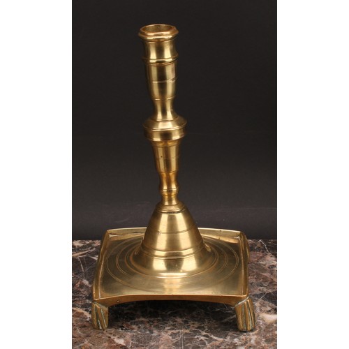 1938 - A Spanish brass tray base socket candlestick, knopped pillar, domed socle, fluted feet, 25cm high, c... 