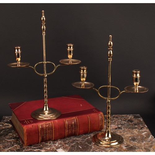 1945 - A pair of early 20th century brass two-light adjustable candelabra, orb-and-knop finiasls, broad dri... 